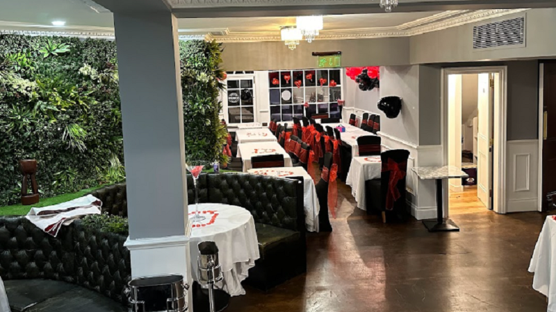 Elegant event space with greenery, ideal for corporate meetings and intimate gatherings.