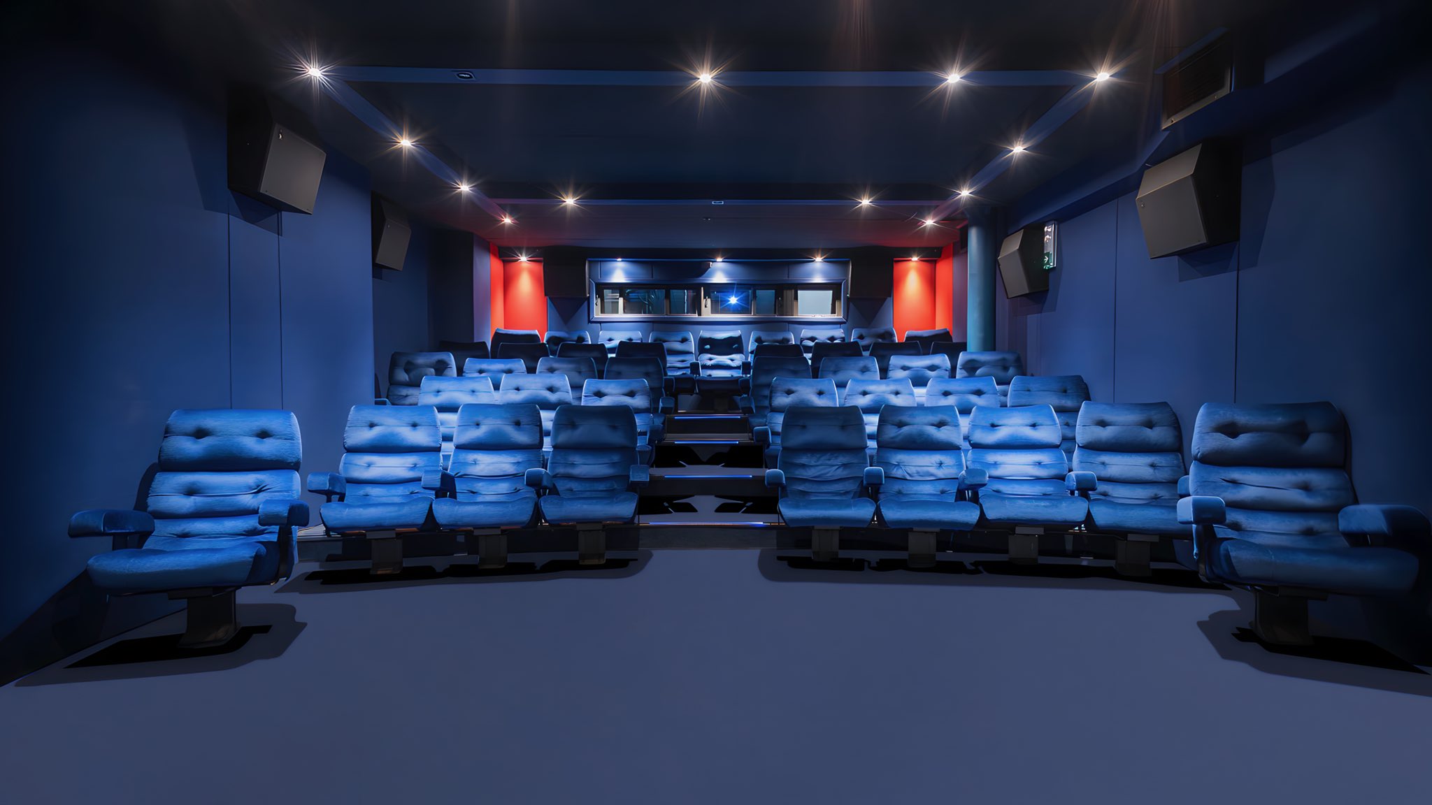 Modern screening room at The Soho Hotel with blue seating, ideal for corporate events.