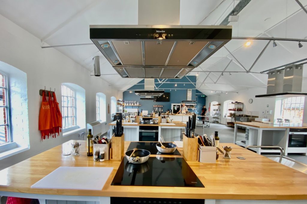 Modern kitchen venue for culinary events and workshops with professional appliances.
