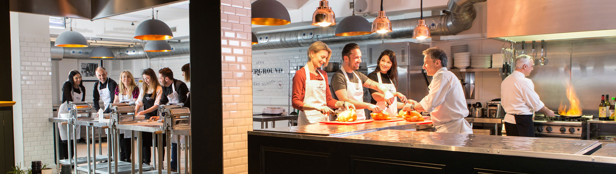 Team-building cooking class in modern kitchen, ideal for corporate events and teamwork.