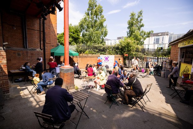 Yard Bar outdoor event space in Stanley Arts, London with vibrant seating and greenery.