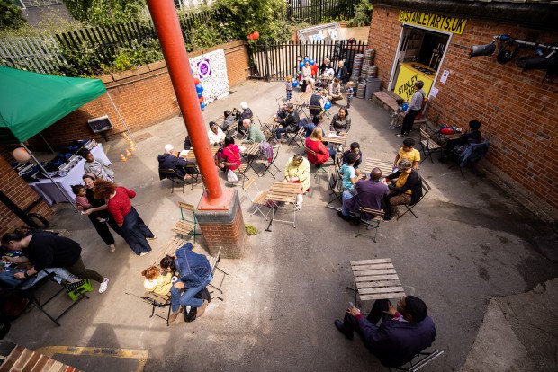 Vibrant outdoor event space at Yard Bar, Stanley Arts, London with green canopy.