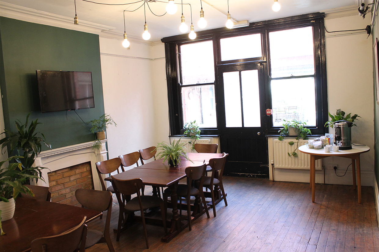 Versatile meeting space in Stanley Arts, London with natural light and greenery for workshops.