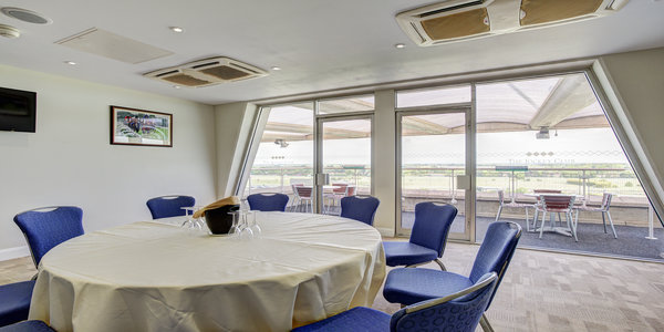 Grandstand Double Box at Sandown Park: round table, blue chairs for meetings and brainstorming.