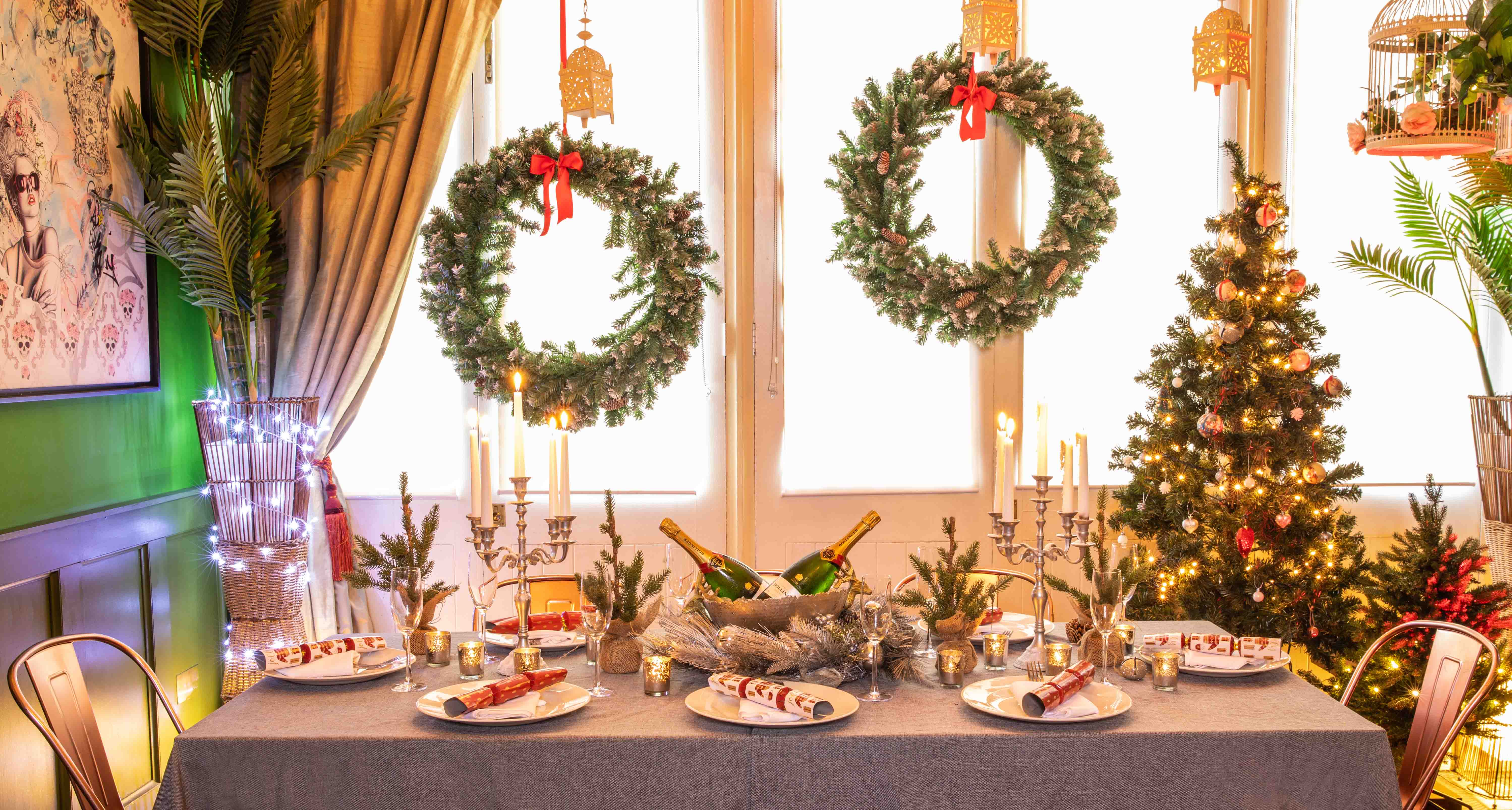 Elegant Christmas event space with festive decor and a sparkling tree at The Little Blue Door.