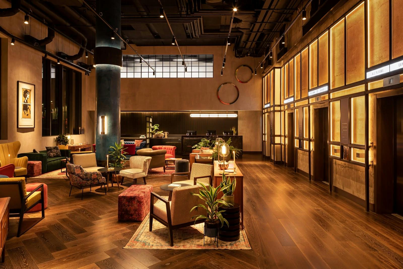 Stylish Coupe Bar lobby with warm lighting, ideal for networking and meetings.