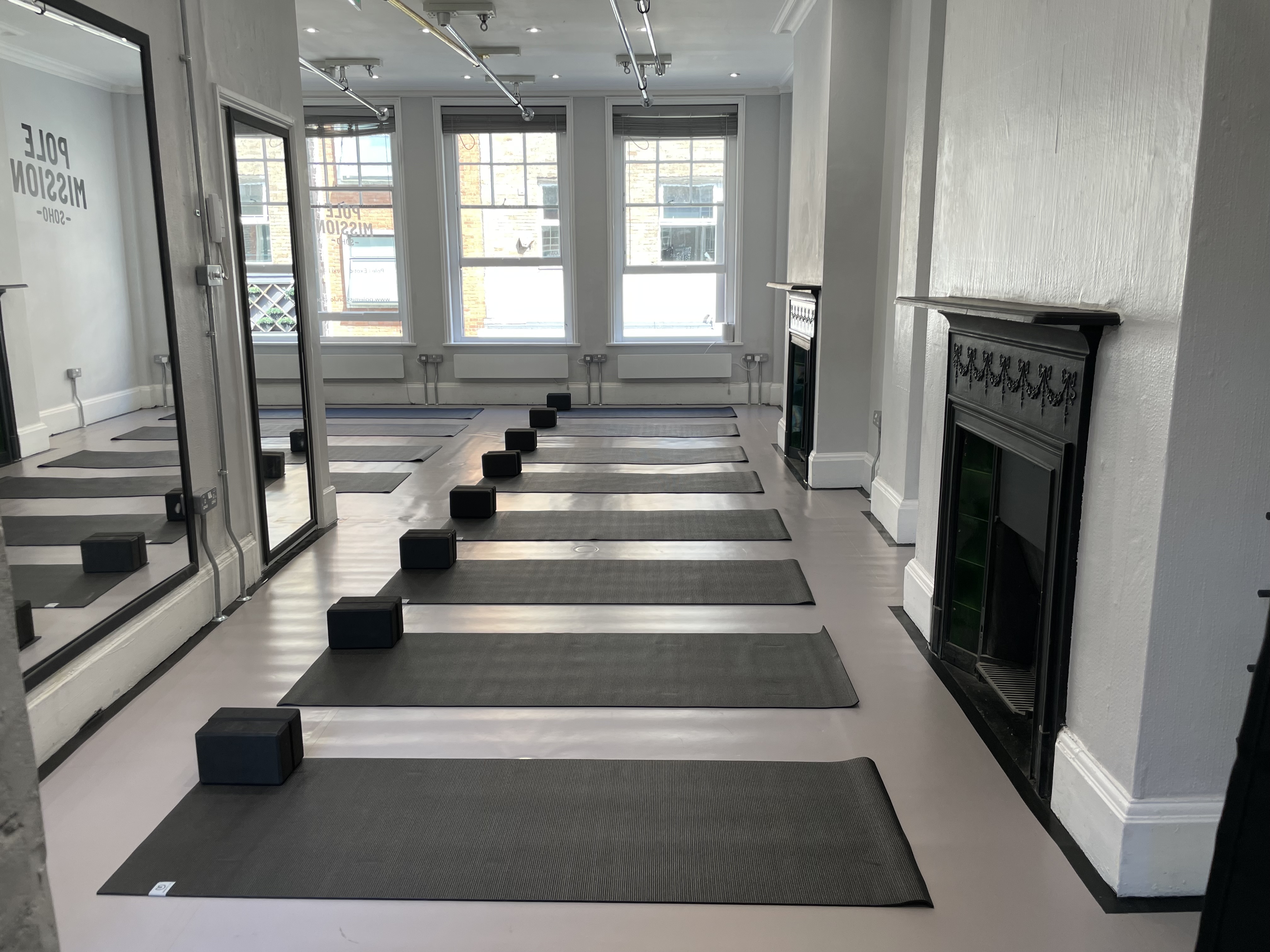 Serene yoga studio with natural light, ideal for wellness retreats and mindfulness sessions.