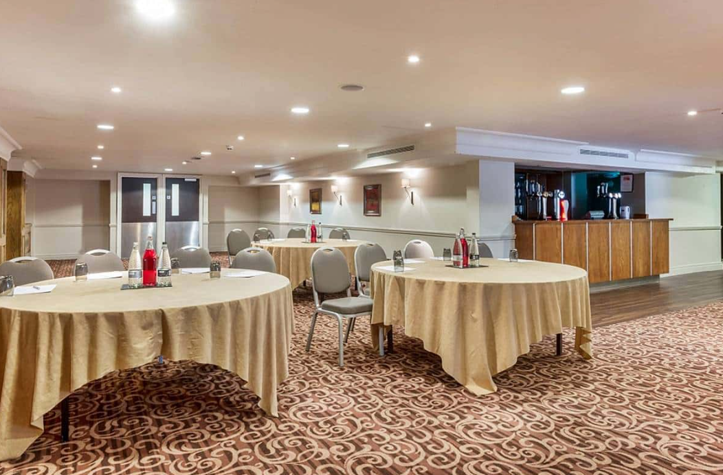 Tatton Suite at Plaza Hotel: versatile meeting space for events with round tables and bar.