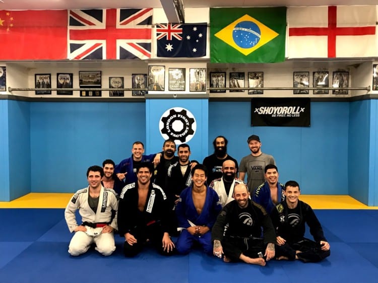 Martial arts training session at London Fight Academy with vibrant blue mats.