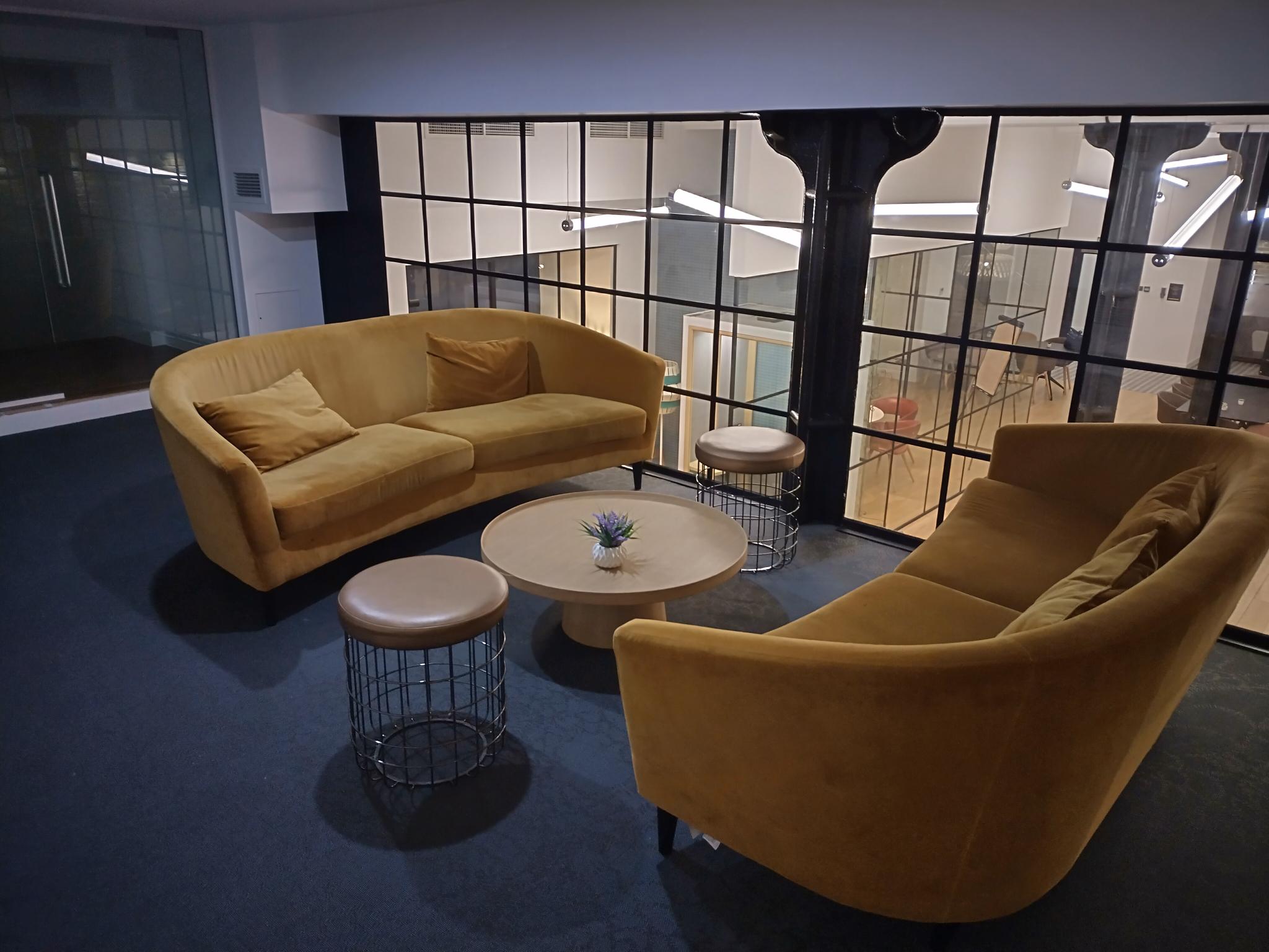 Stylish lounge area with curved sofas in Clerkenwell Event Space for networking events.