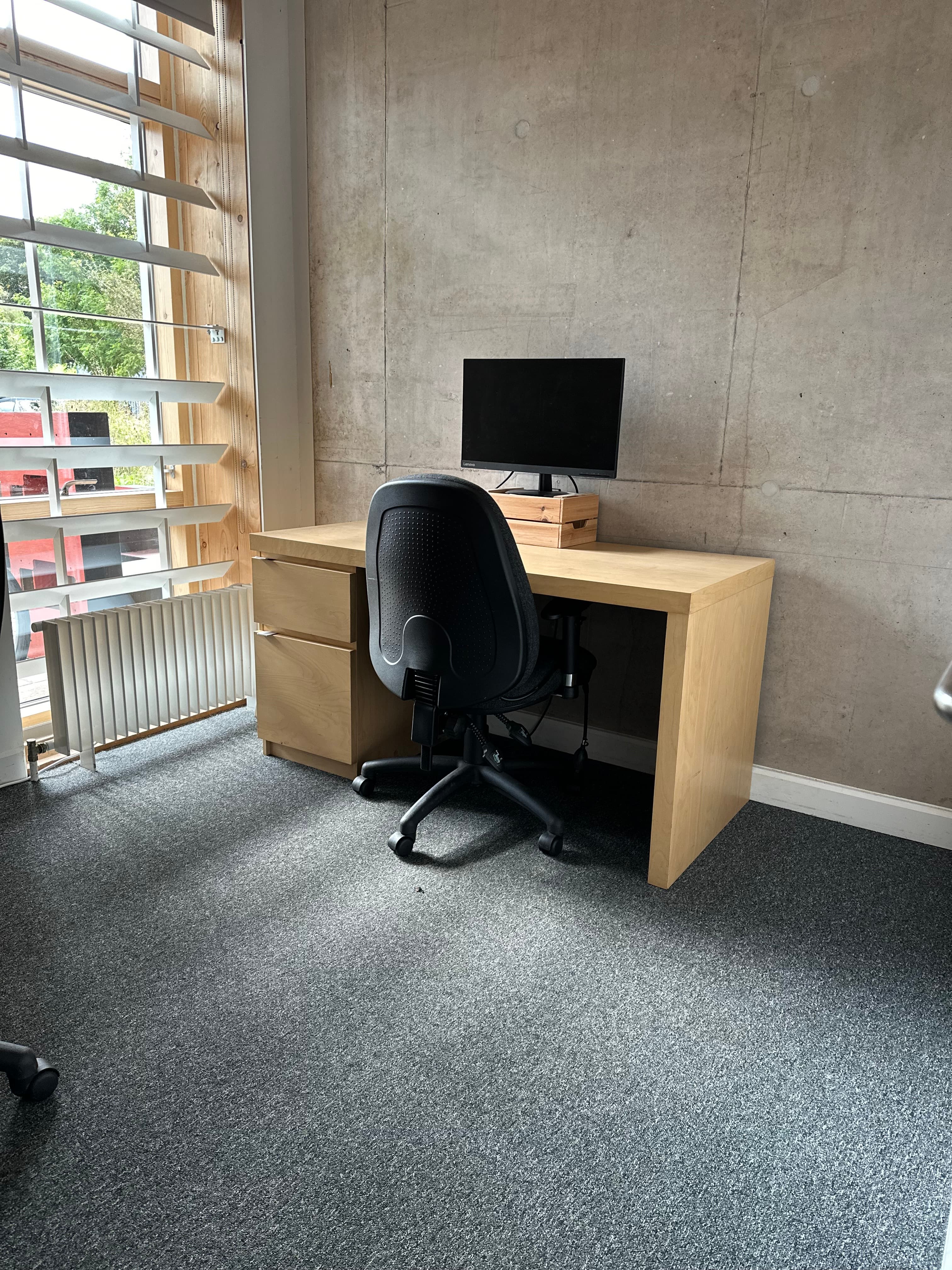 Digital Dark Room workspace with ergonomic chair for virtual meetings, ideal for event planning.