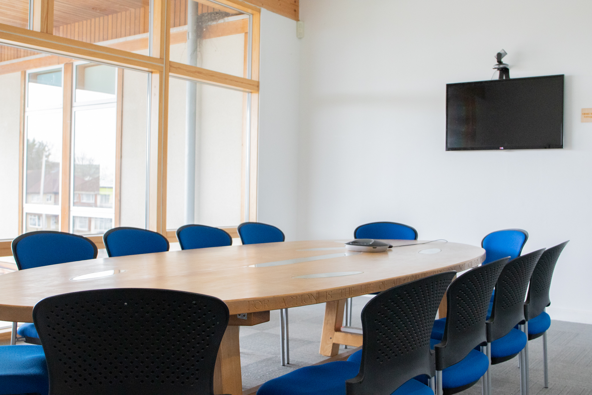 Modern conference room at Knowle West Media Centre with a large wooden table for meetings.