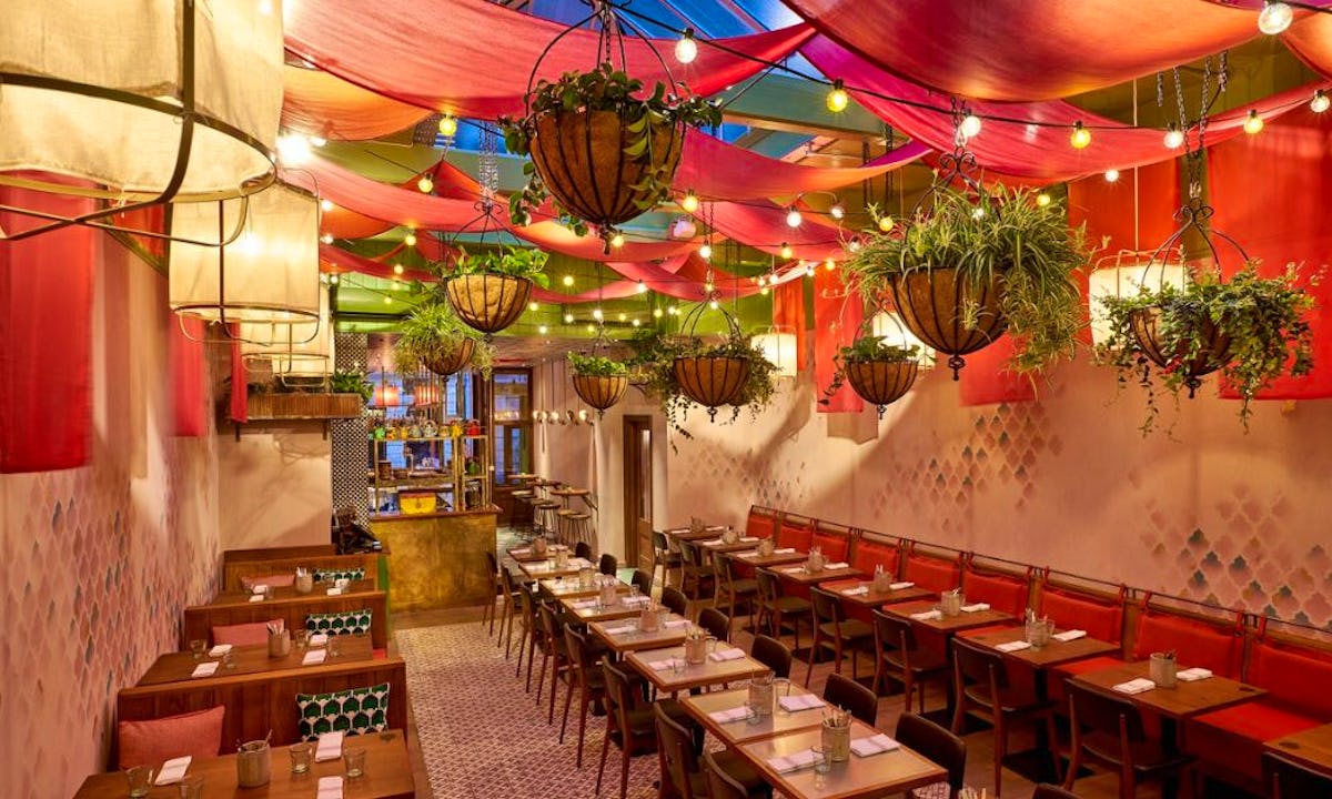 Vibrant event space at Cool Carrot with colorful drapery, perfect for gatherings.