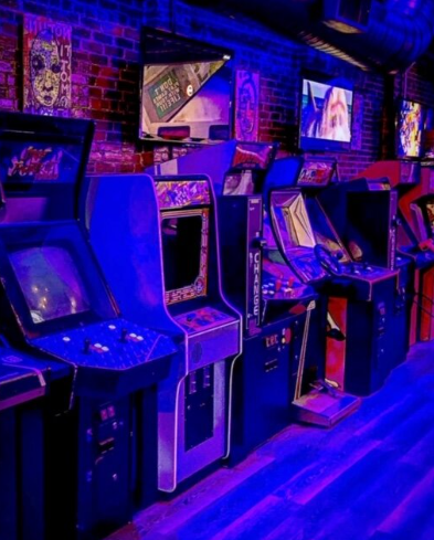 Vibrant arcade bar with classic games, ideal for team-building and networking events.