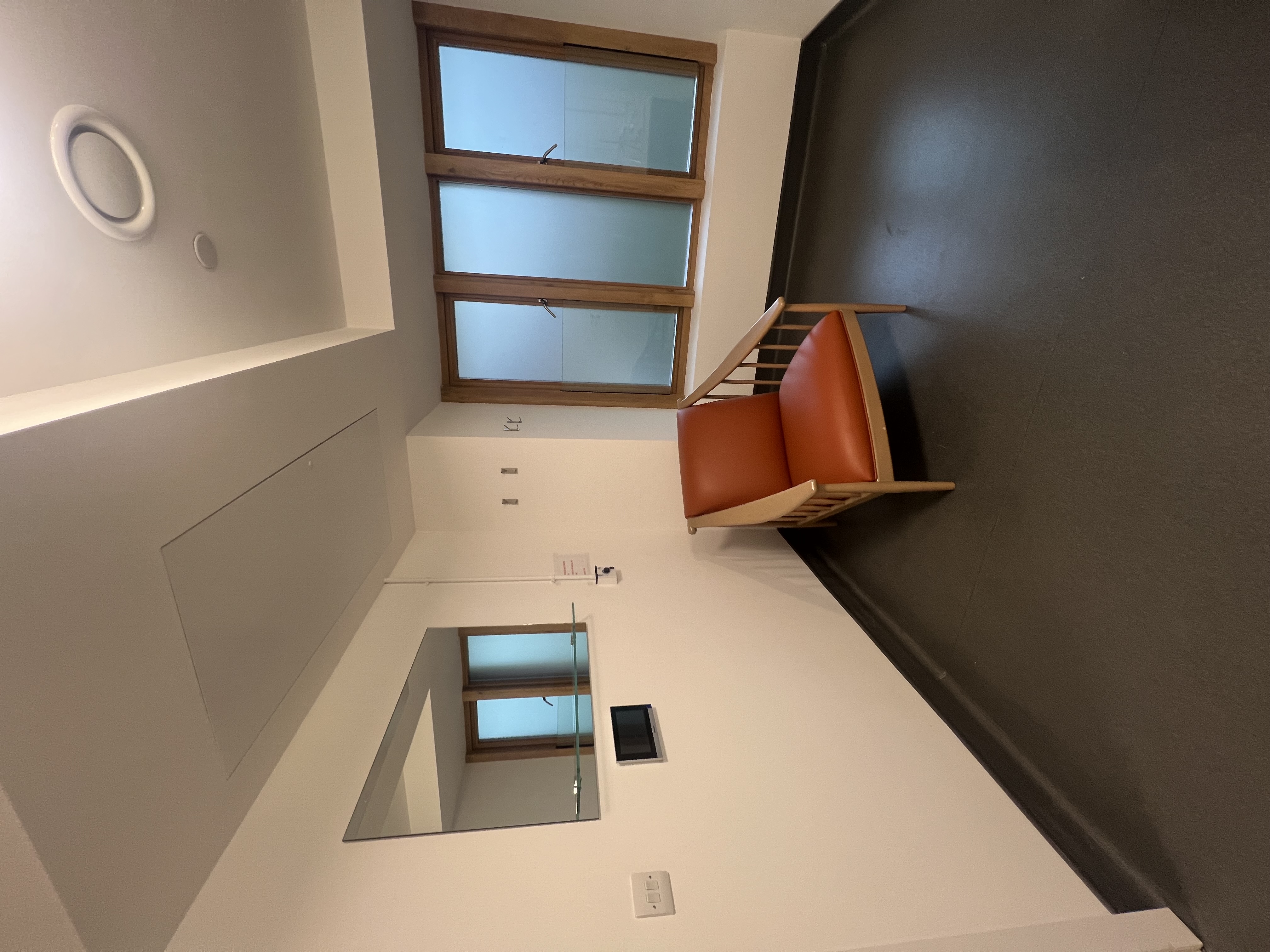 Minimalist meeting space in Bermondsey Spa with modern chair and frosted windows.
