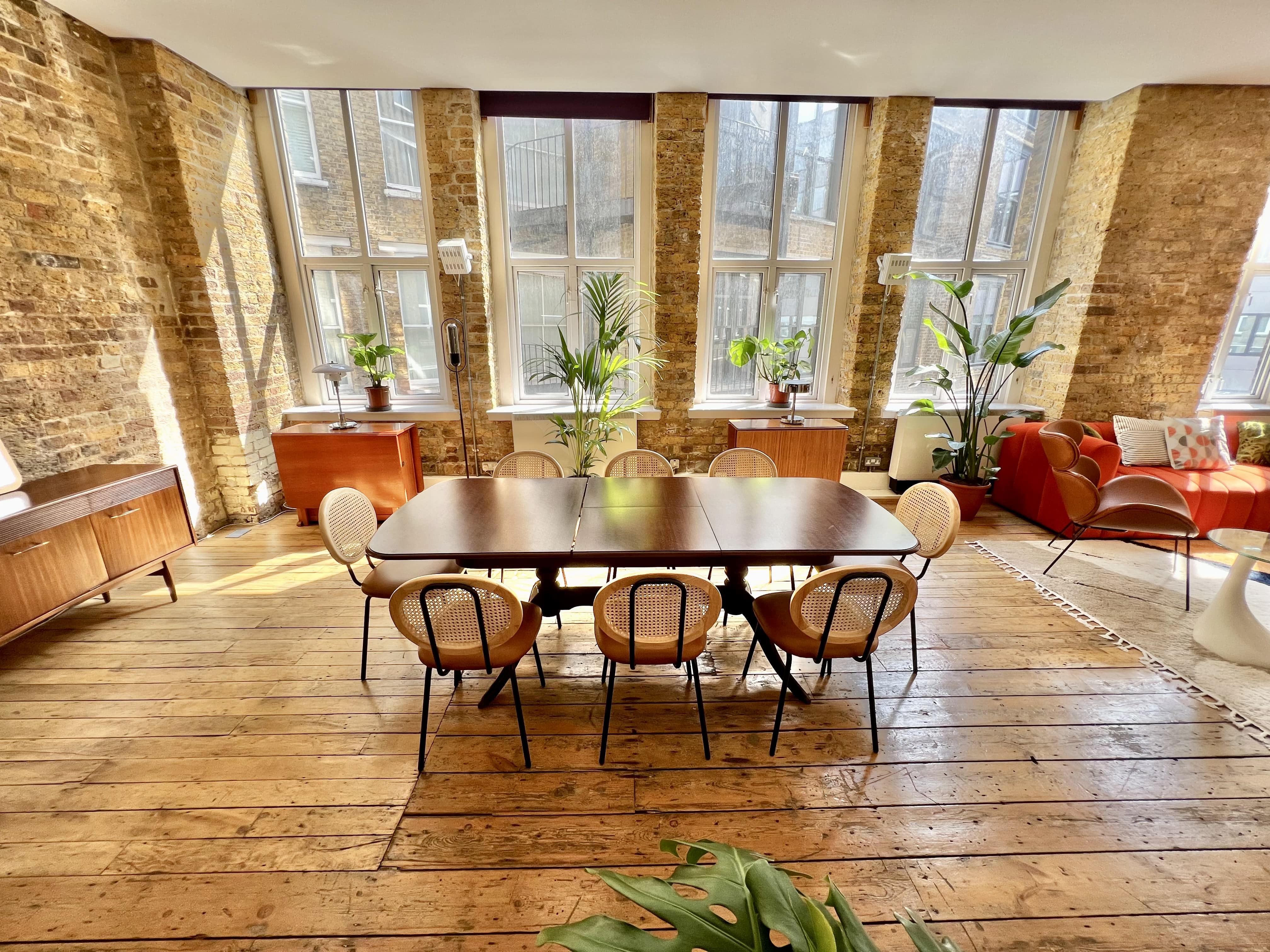 Bright meeting space with large windows in The Artist's Loft, ideal for creative gatherings.