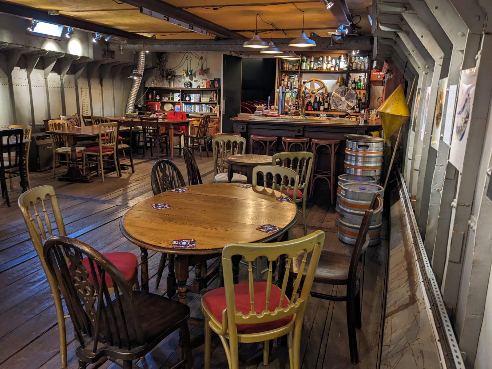 Rustic event space with wooden tables, ideal for gatherings and celebrations.