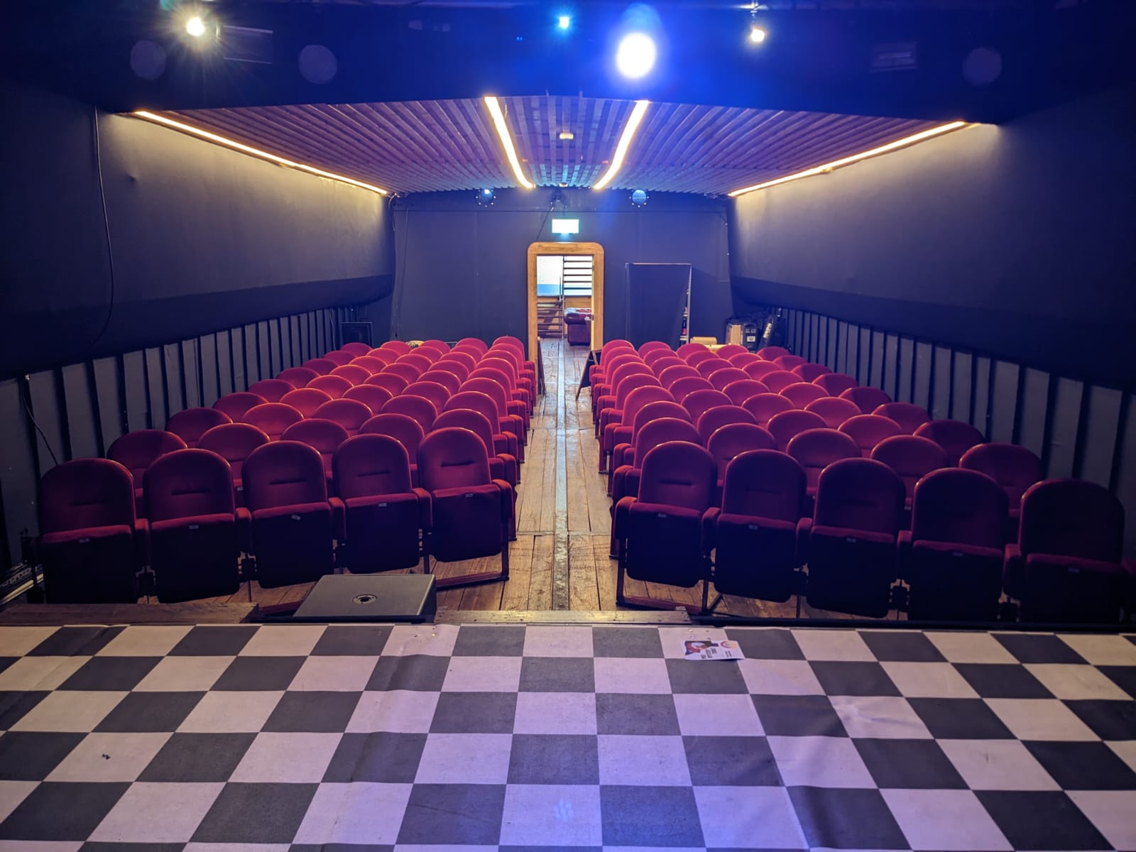 Event Space in Theatreship with red seating, ideal for conferences and performances.