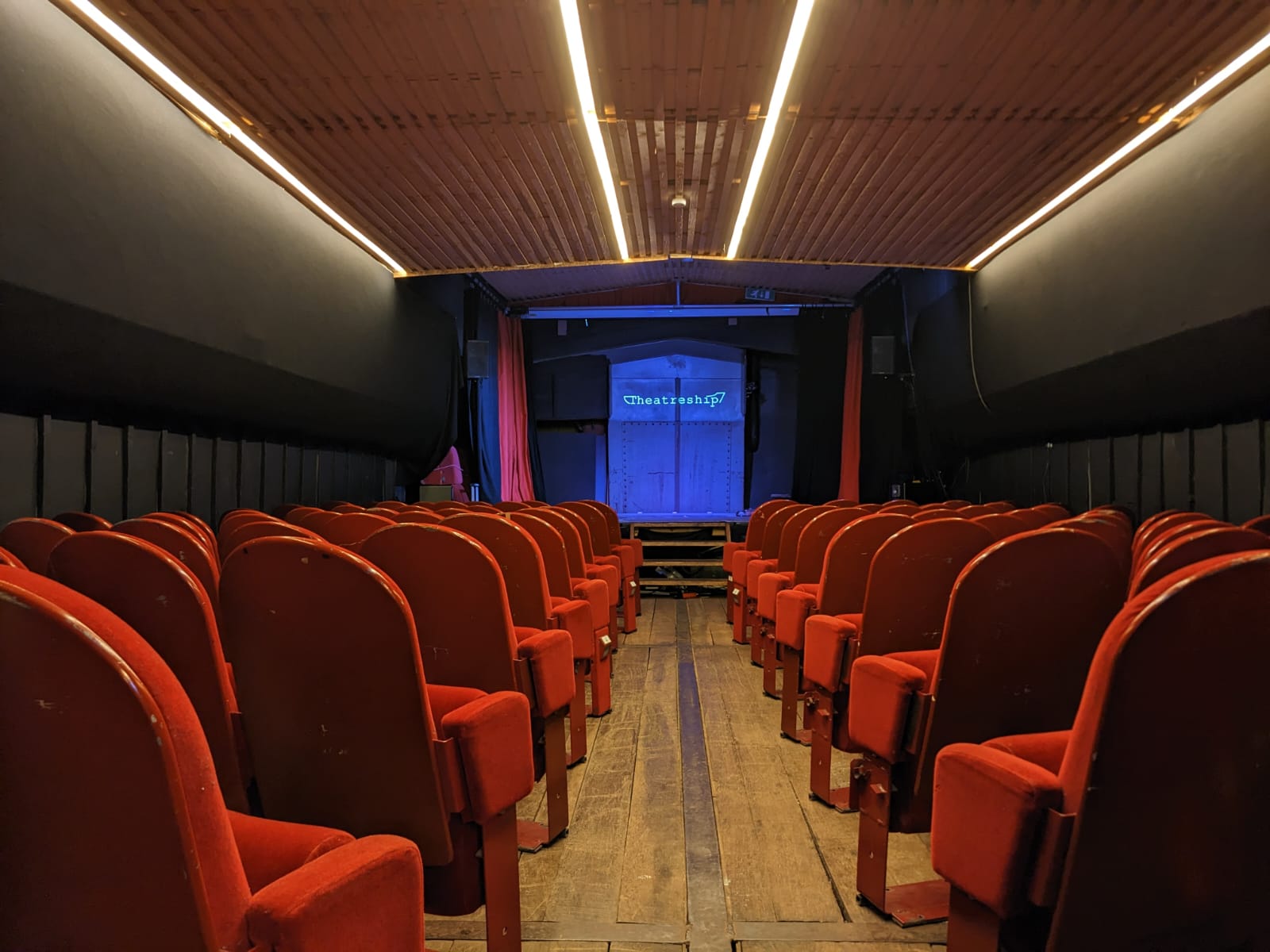 Event Space in Theatreship with red seating, ideal for conferences and workshops.