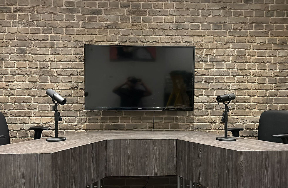 Modern comedy club setup with microphones and TV for panel discussions.