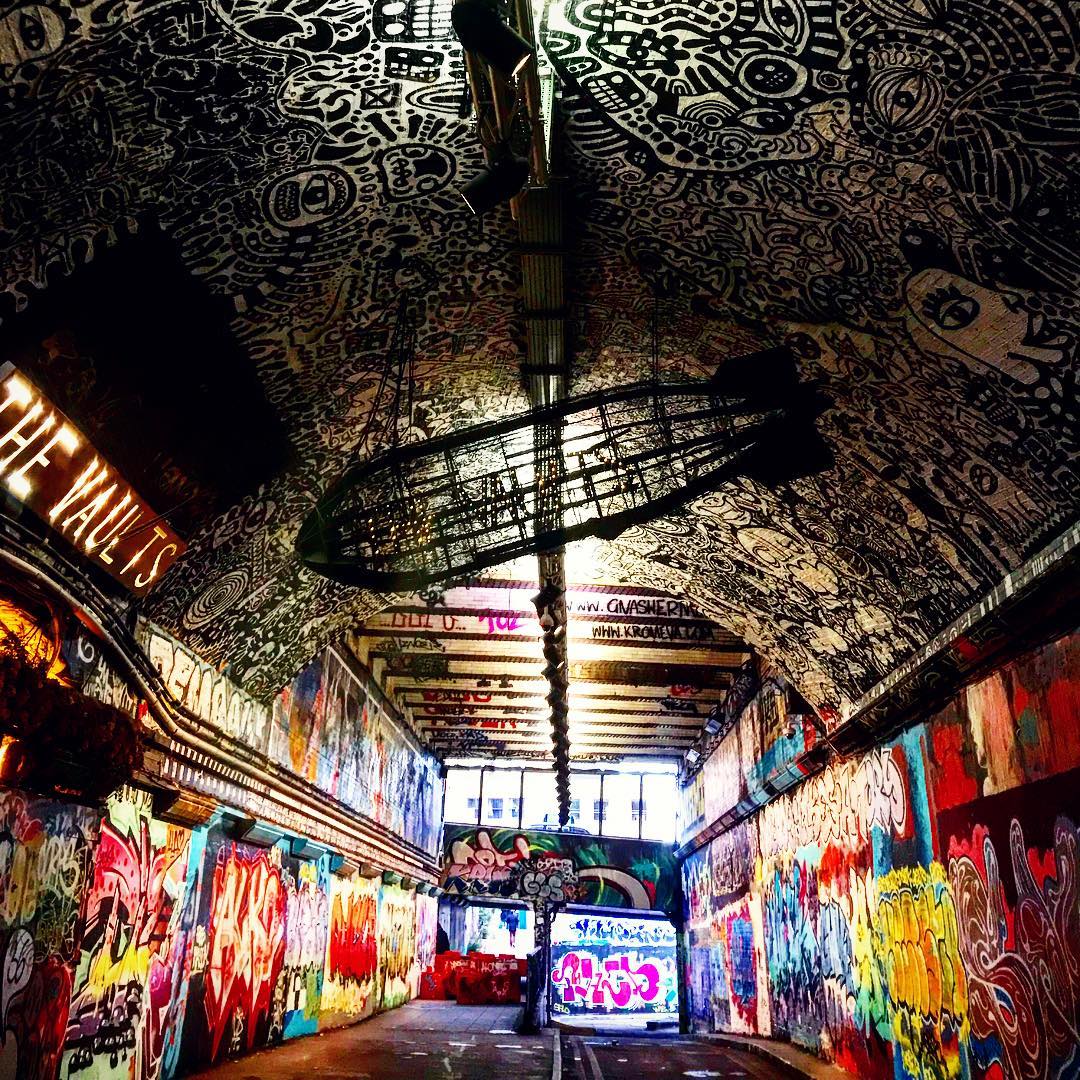 Vibrant graffiti-covered venue in The Vault for creative events and art exhibitions.