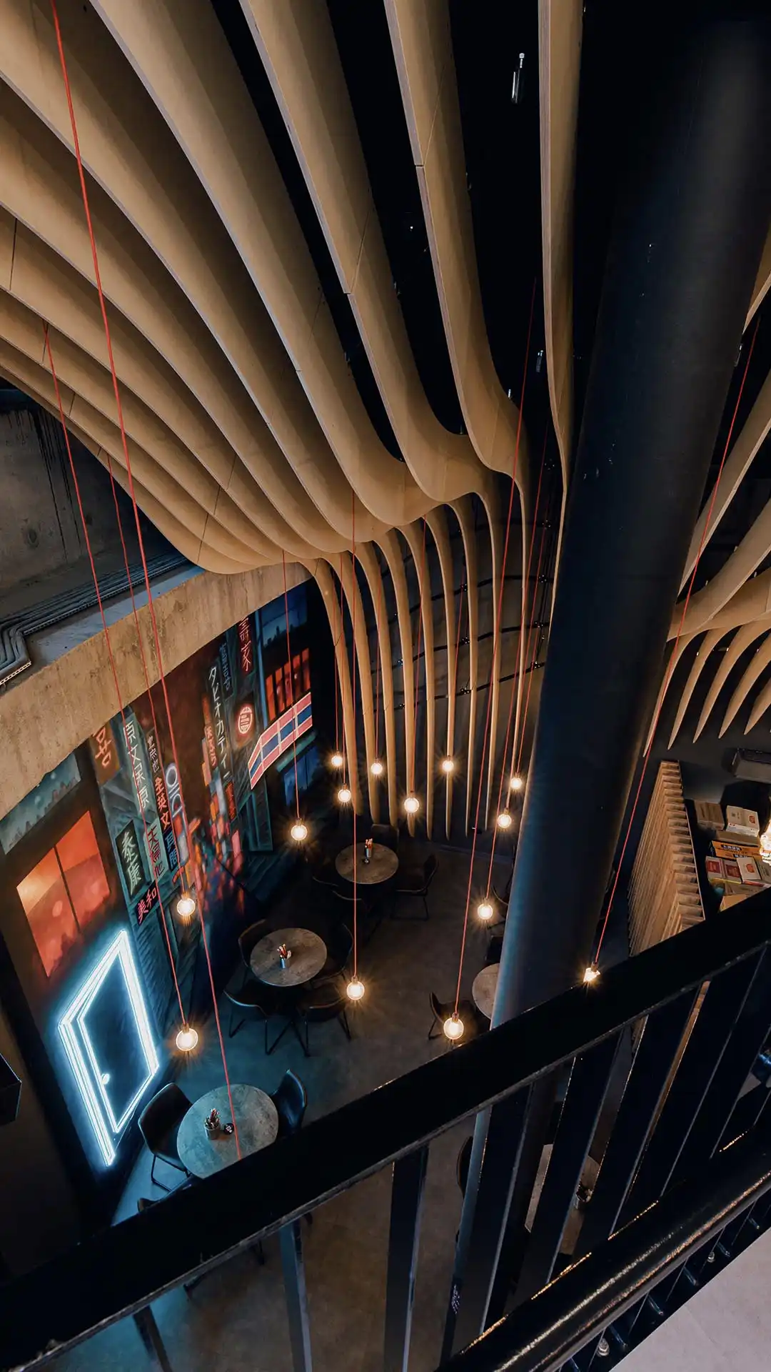 Modern basement event space with curved wood features, ideal for meetings and gatherings.