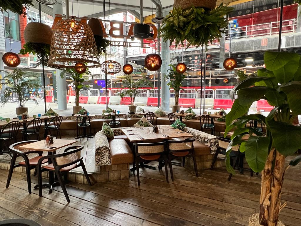 Vibrant dining space with greenery for casual meetings and networking events at St Giles.