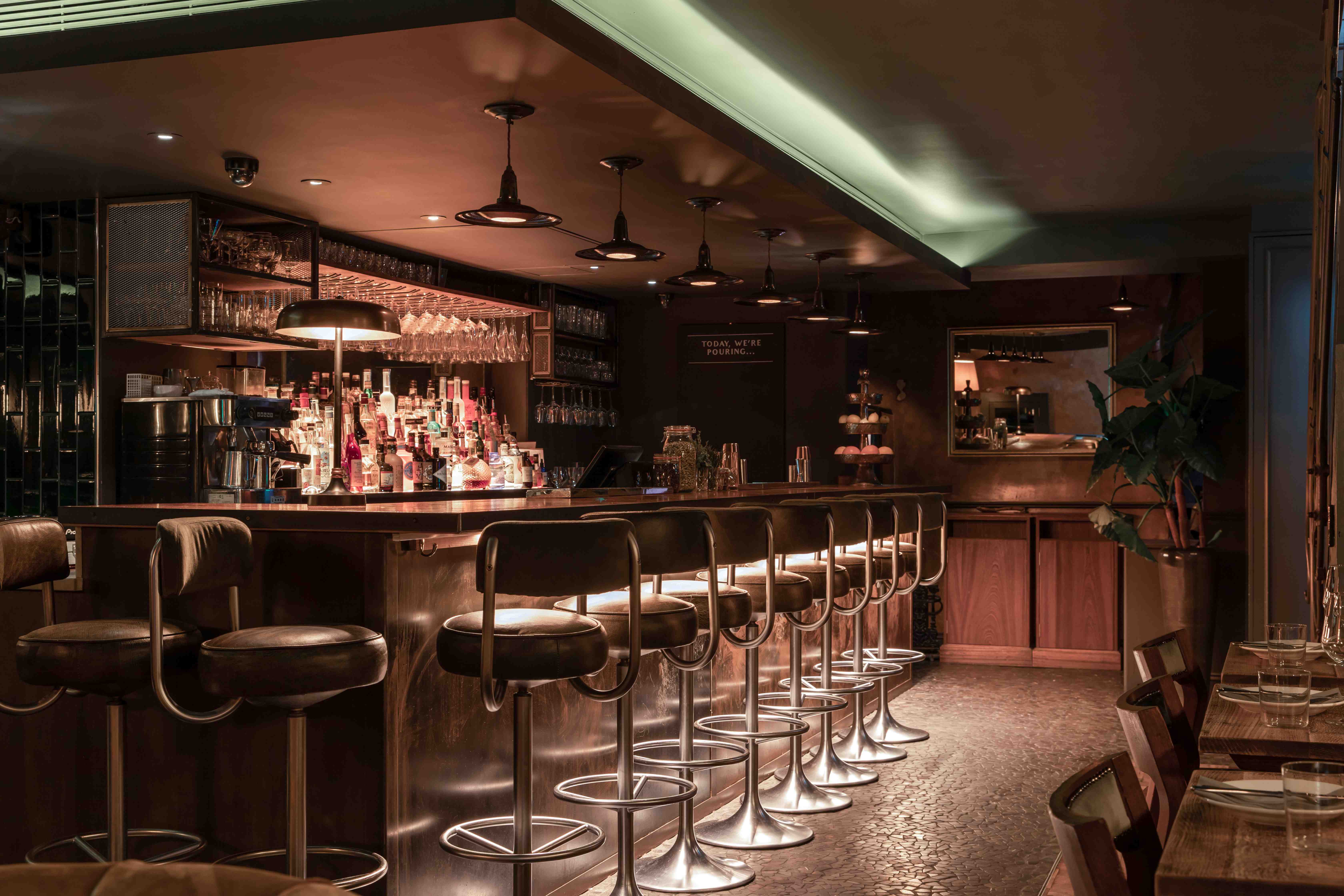 Stylish Ember Bar with warm lighting, perfect for networking events and cocktail receptions.