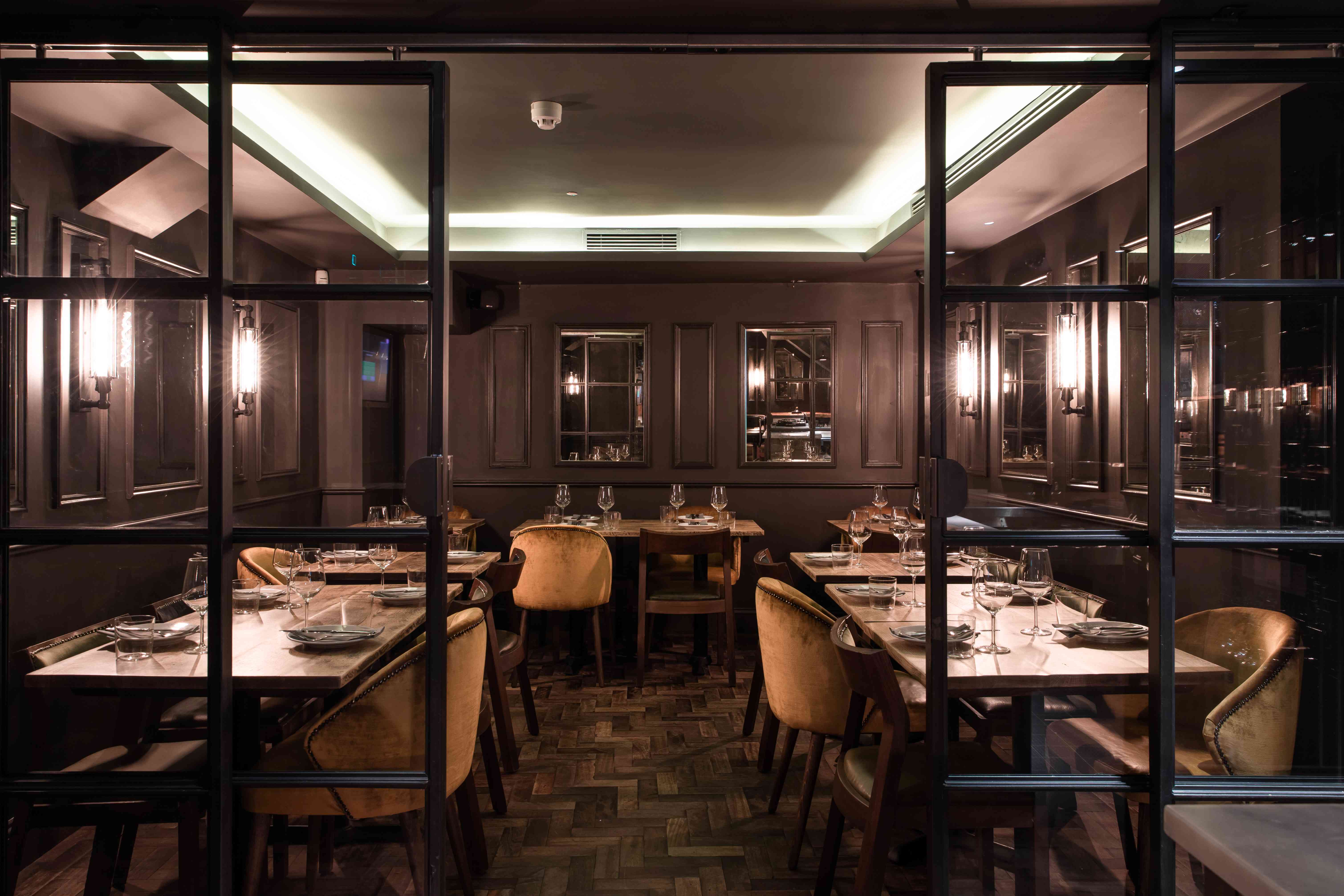 Sophisticated Ember Bar dining space with warm lighting for private events and meetings.