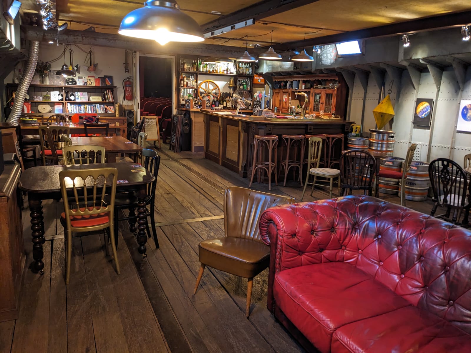 Cozy rustic theatre space with warm lighting for intimate gatherings and networking events.