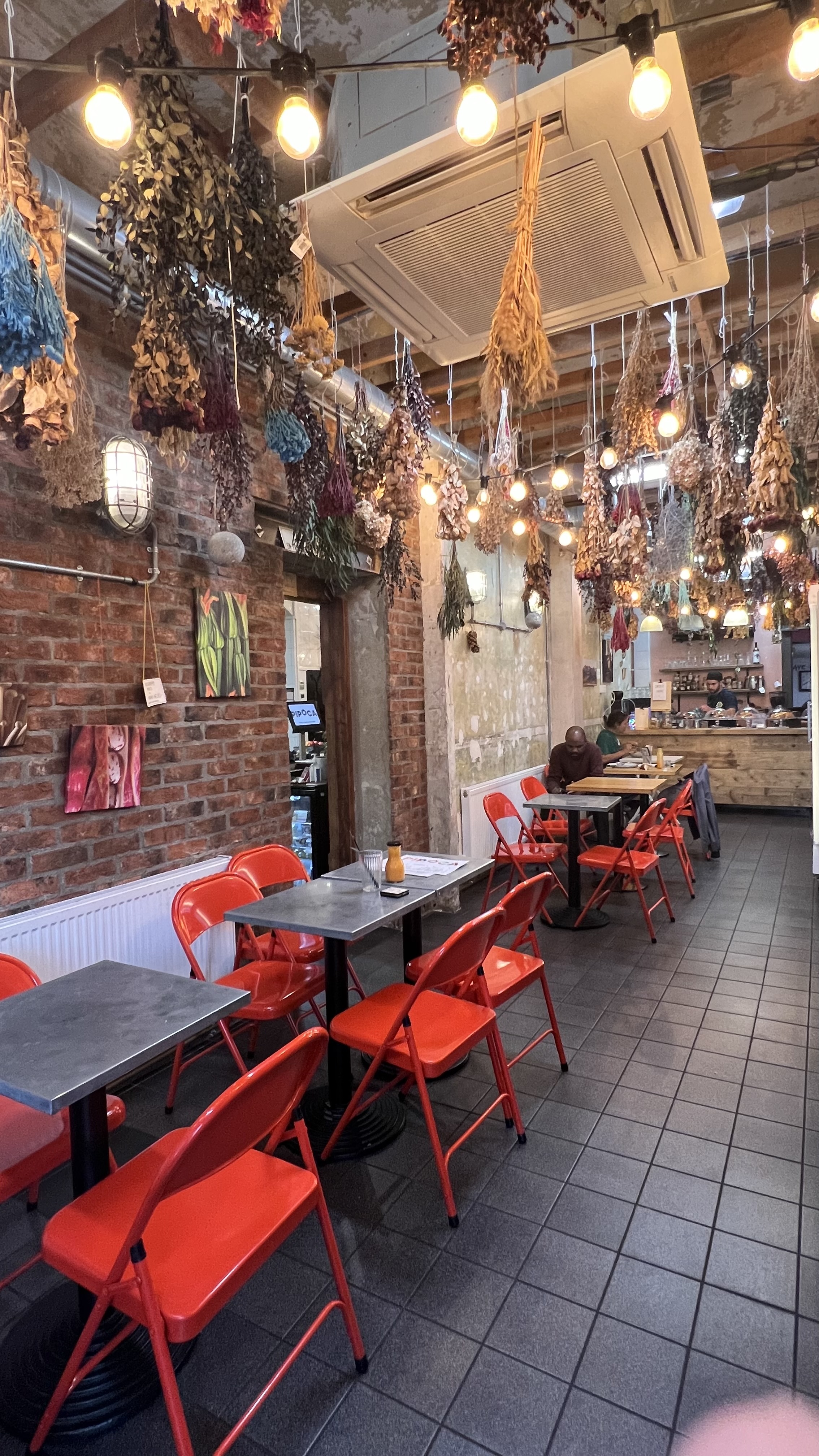 Cozy Pipoca Vegan Bar with warm lighting, perfect for casual meetings and events.