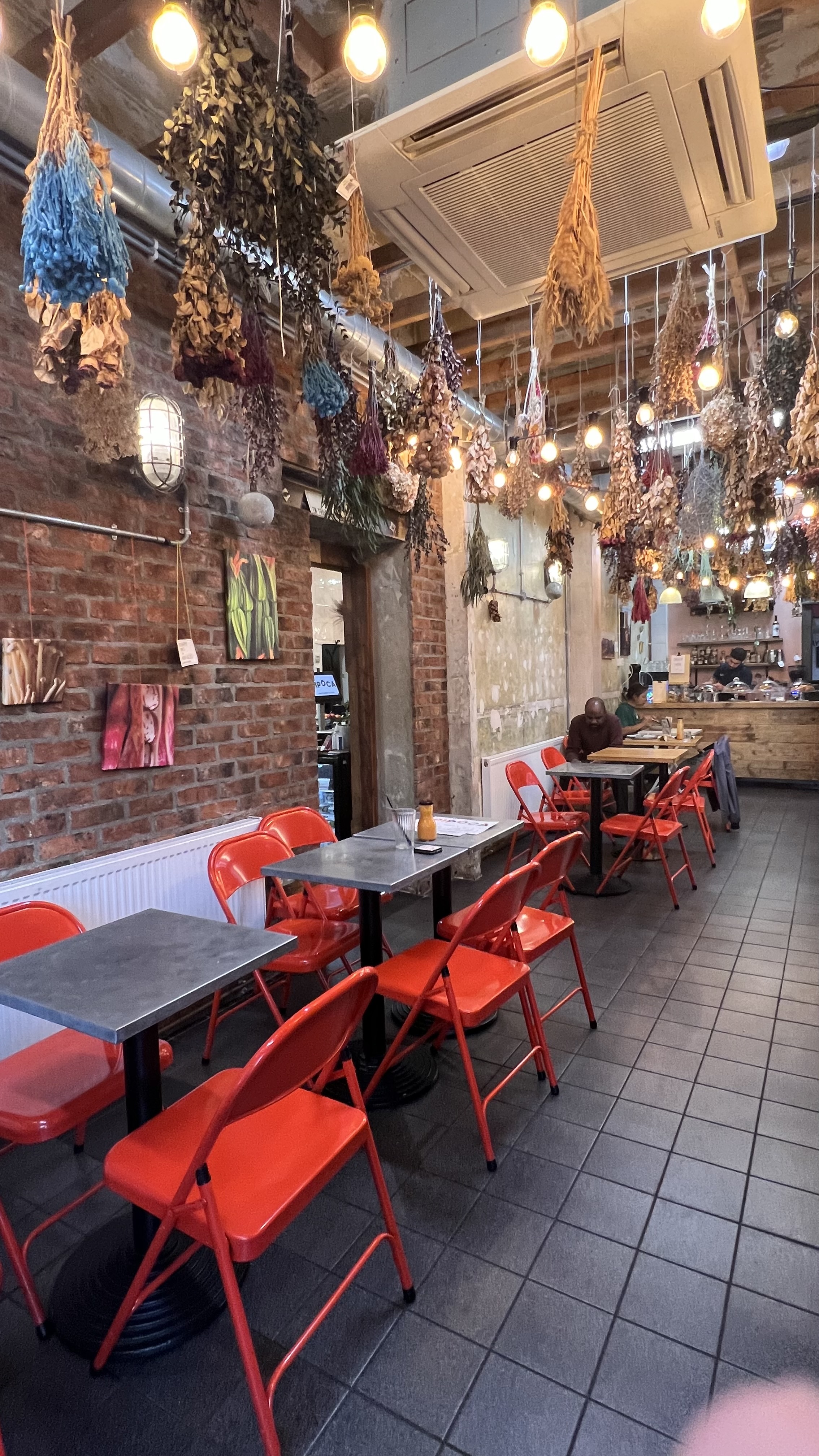 Cozy Pipoca Vegan Bar with vibrant orange chairs, perfect for casual meetings and gatherings.