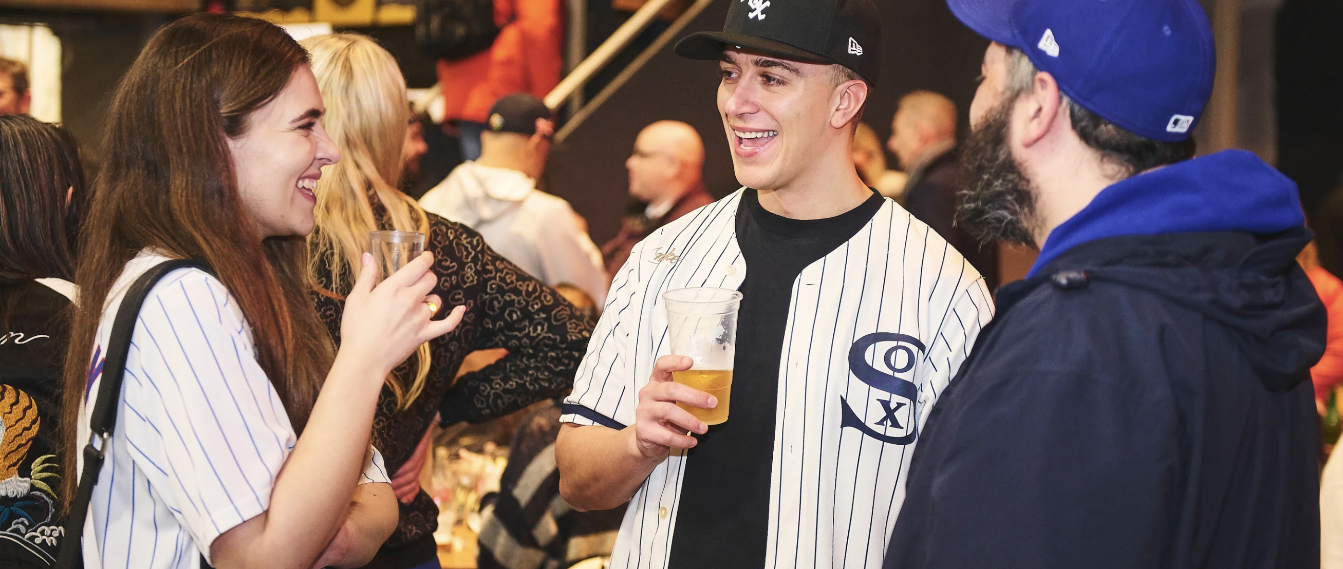 Lively sports-themed networking event with attendees in baseball jerseys.