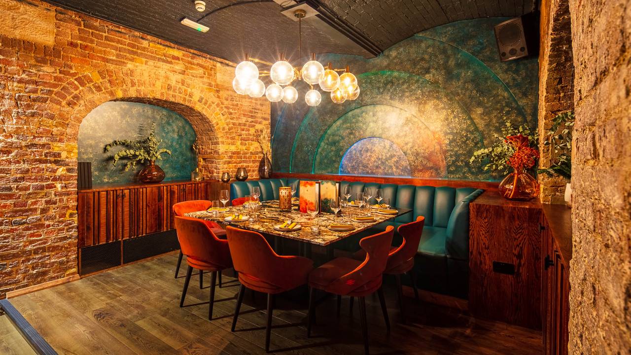 Stylish private dining area with warm lighting for corporate events and intimate dinners.