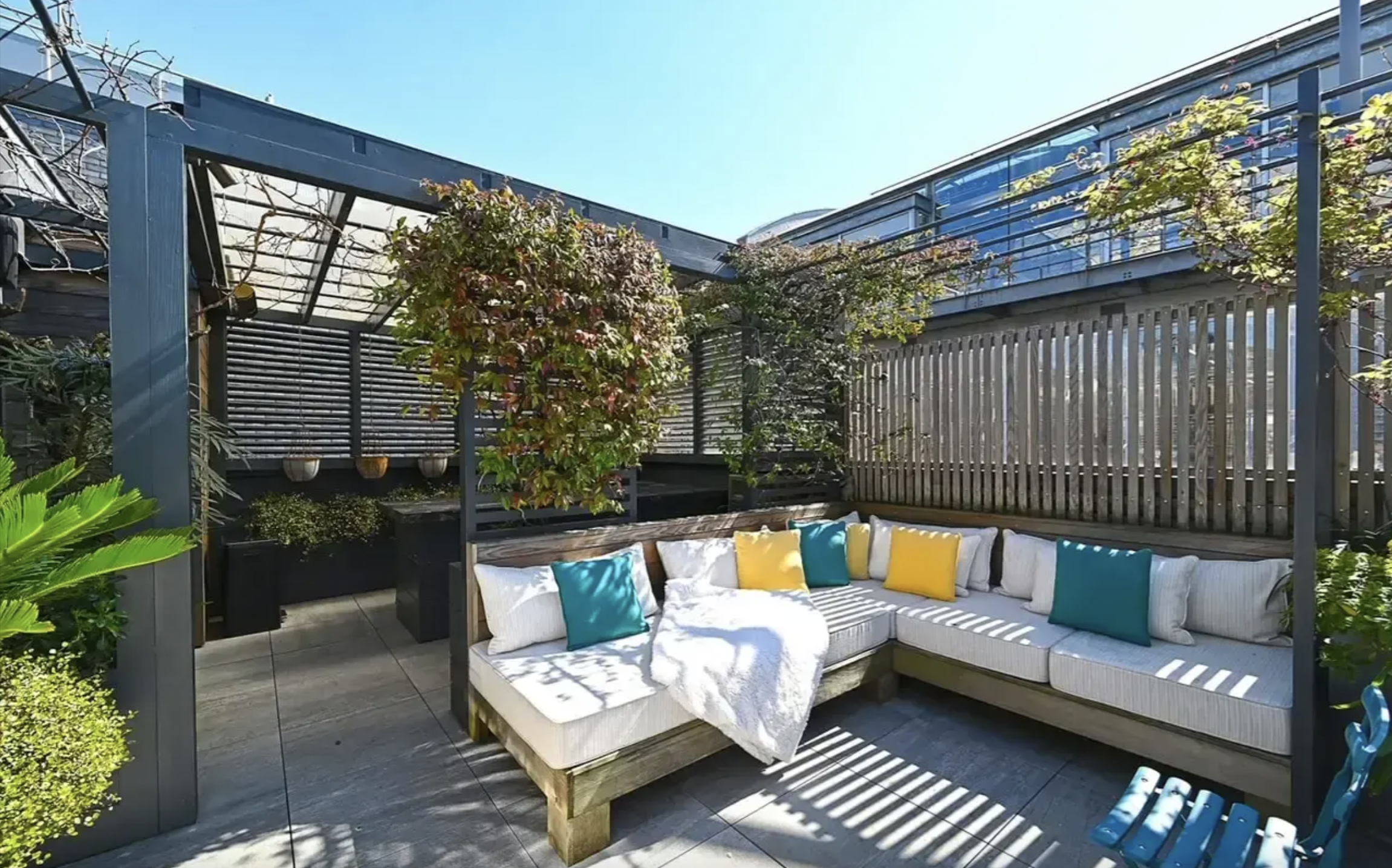Roof terrace lounge with vibrant cushions, ideal for networking events and casual meetings.