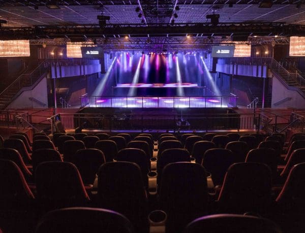 Concert stage with vibrant lighting at Palladium Times Square for concerts and events.