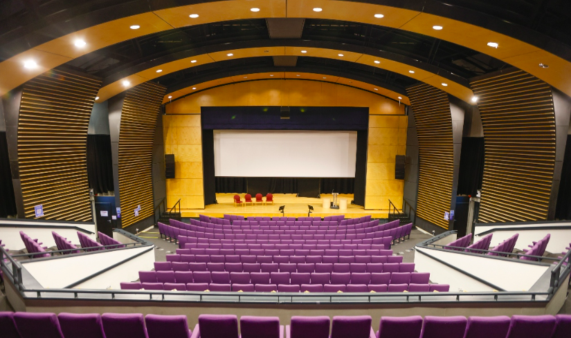 Weston Auditorium at University of Hertfordshire with tiered purple seating for events.