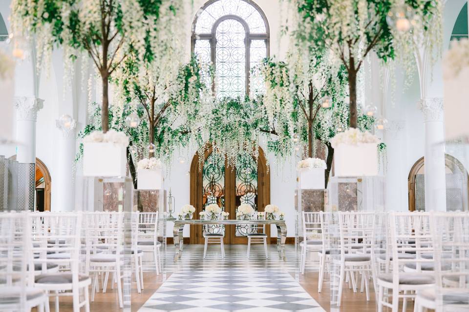 Elegant event space at Hawkstone Hall, perfect for weddings with floral decor and stained glass.
