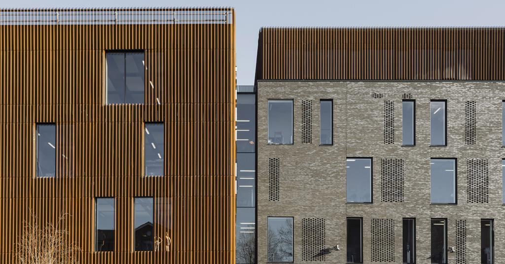 Modern conference room with wooden slats, perfect for corporate events and workshops.