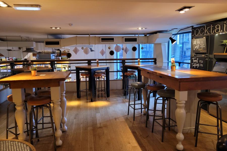 Stunning modern dining room with high-top tables, ideal for networking events.