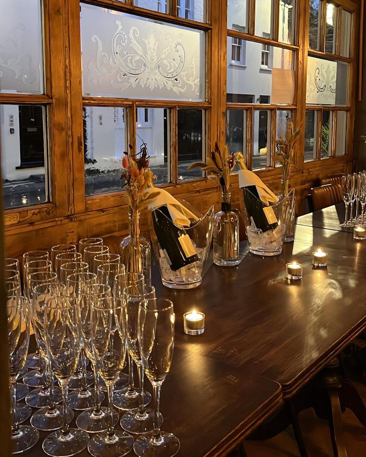 Elegant dining room at The Wilton Arms with champagne, perfect for upscale events.