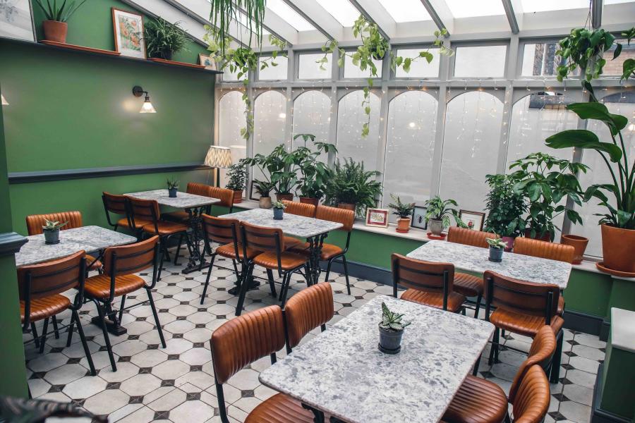 Victorian pub meeting space with marble tables, ideal for gatherings and brainstorming.