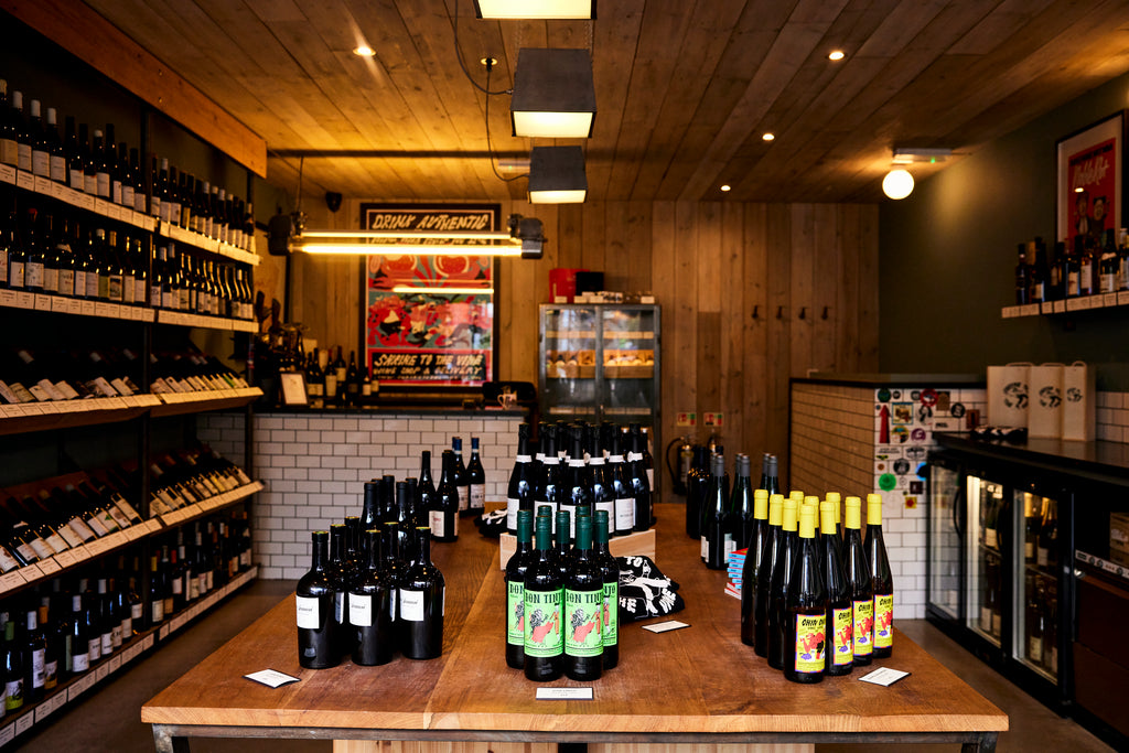 Cozy wine shop bar with warm lighting, ideal for tastings and private events.