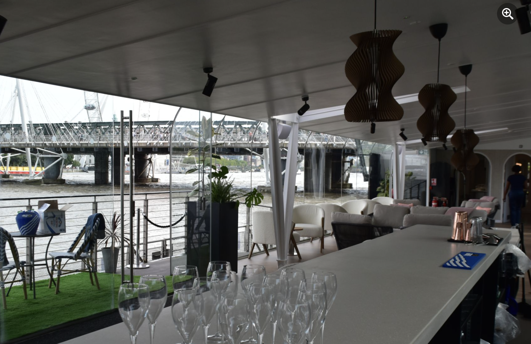 Stylish boat event space with sleek bar and waterfront views for networking gatherings.