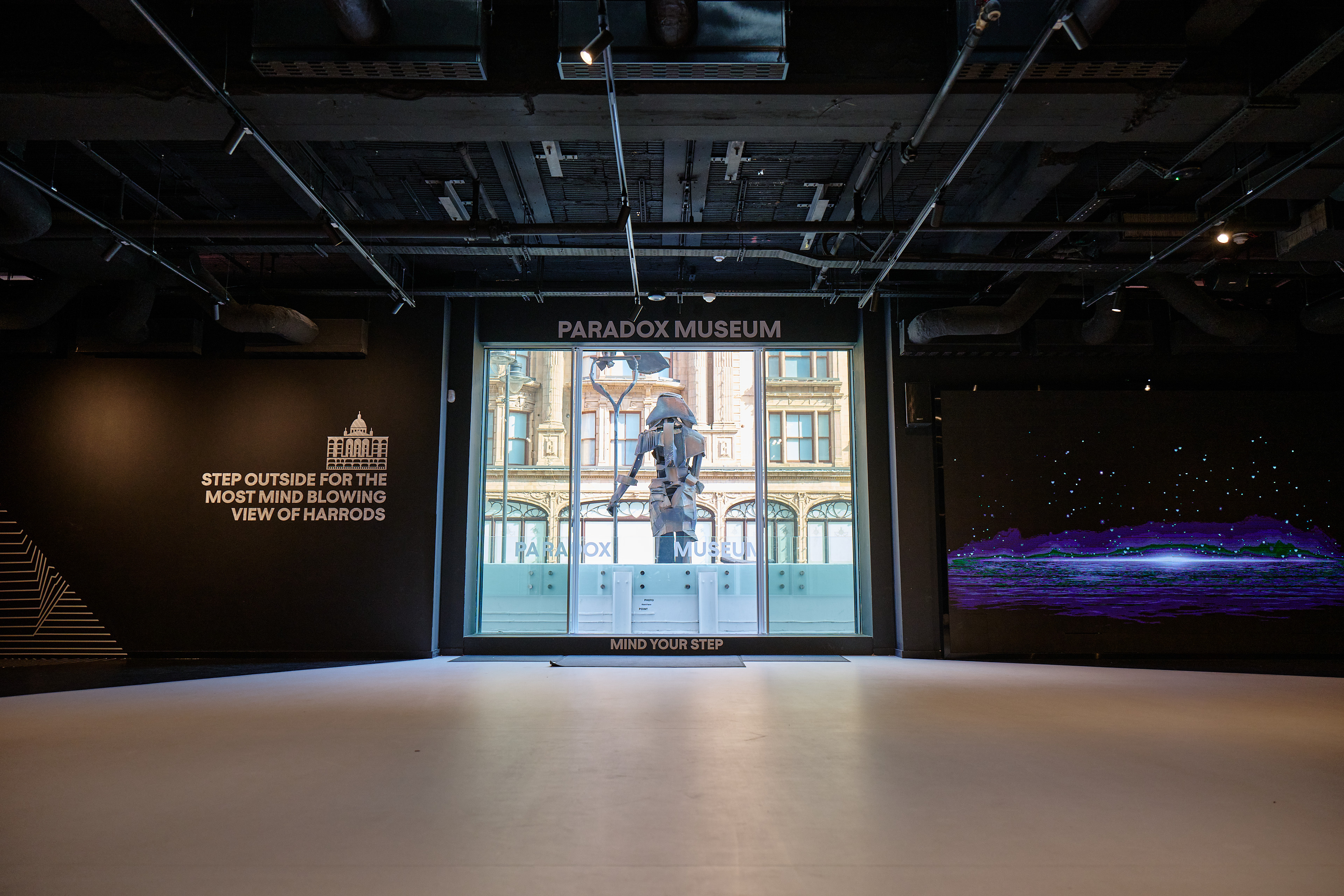 Modern event space at Paradox Museum London with large window and dynamic lighting.