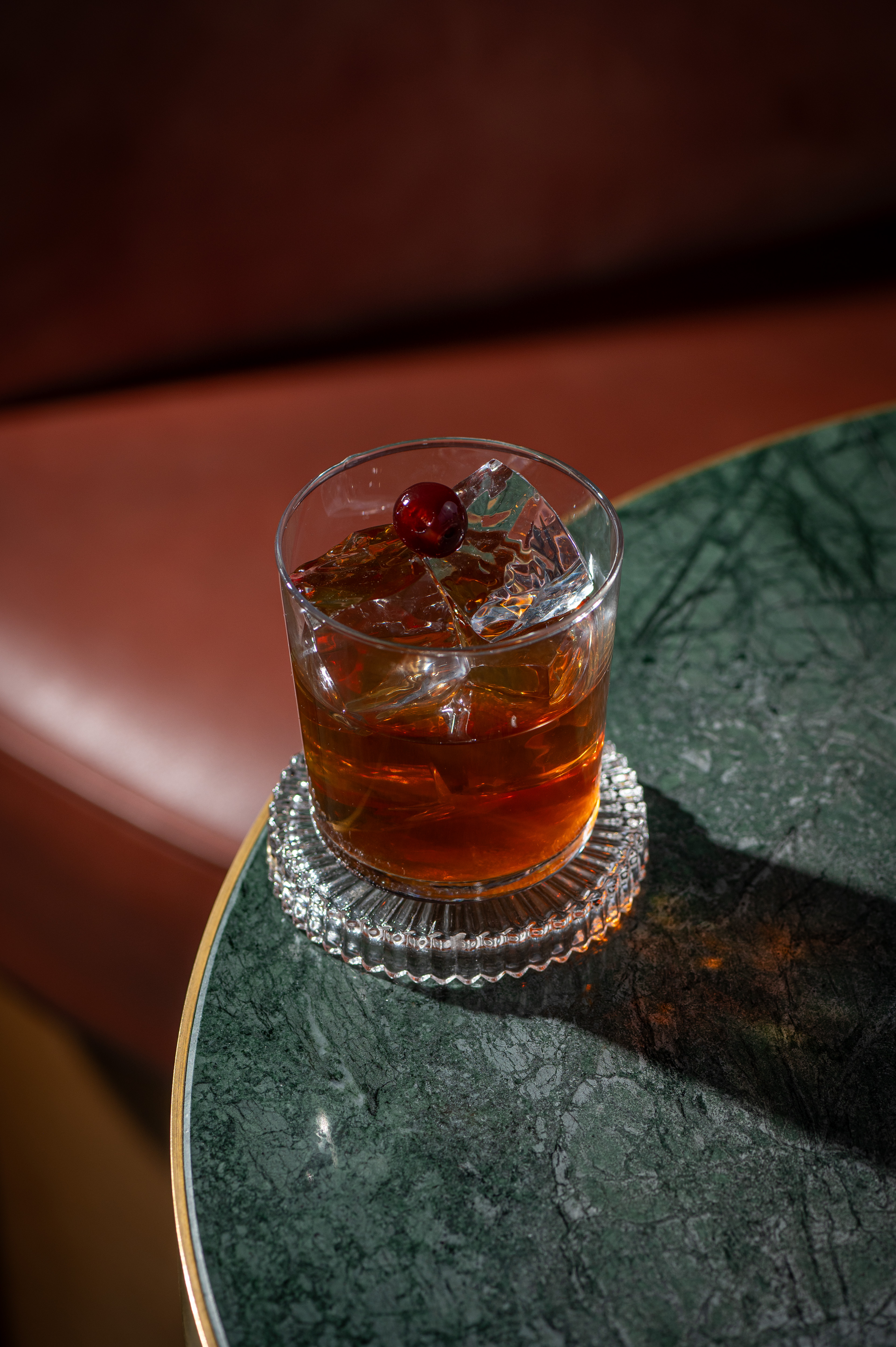 Elegant cocktail with cherry garnish at The Bar, Clays Birmingham for networking events.