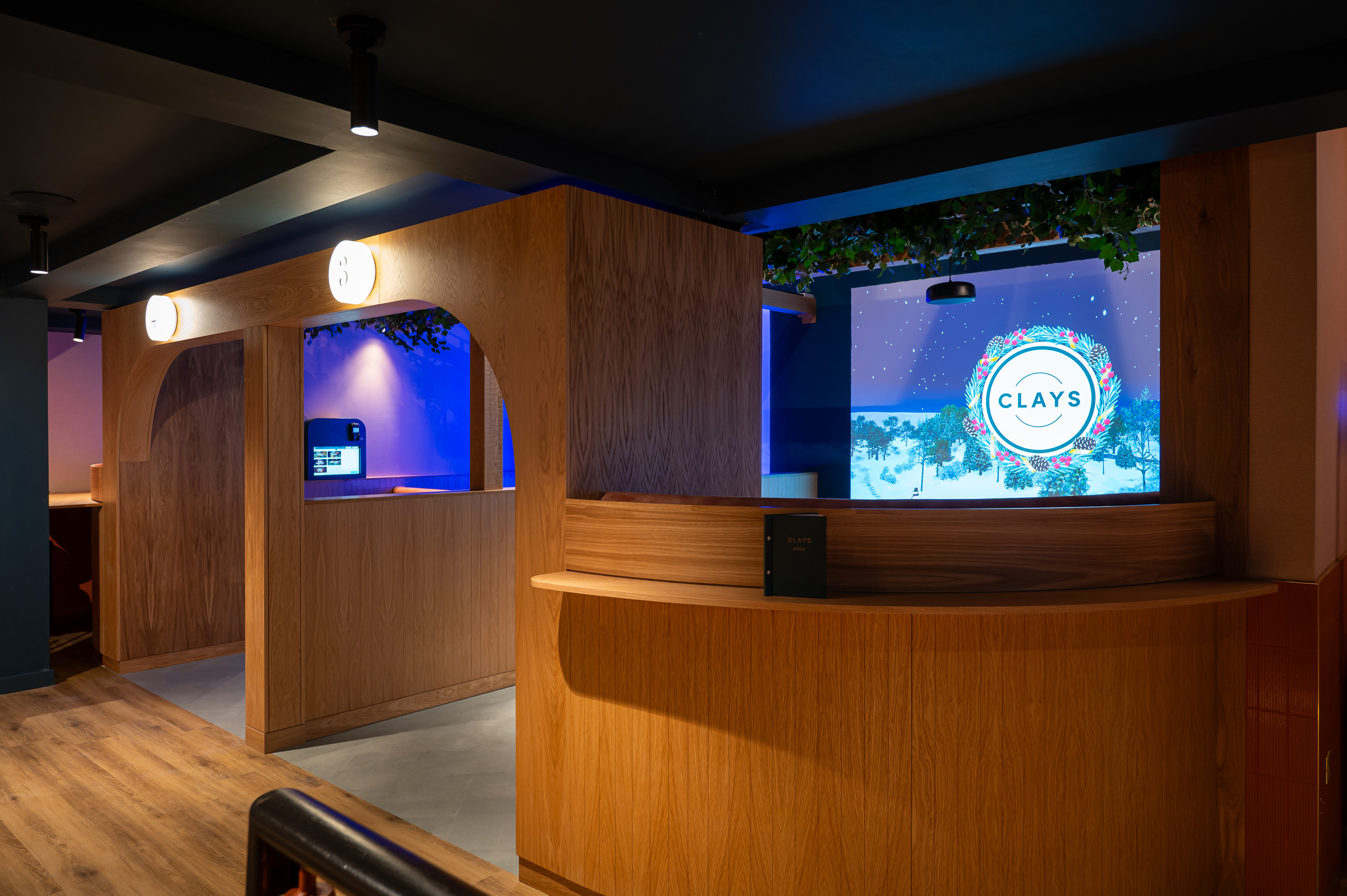 Modern event space in Clays Birmingham with sleek reception and vibrant lighting.