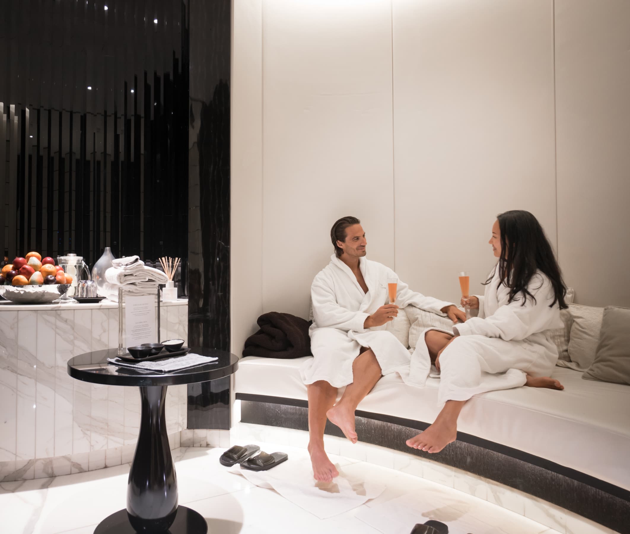 Guests in plush robes relax at Khamam Spa, ideal for wellness events and retreats.