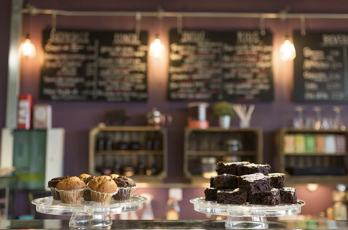 Refreshment station with muffins and brownies at YMCA/Purplespoon Cafe for networking events.