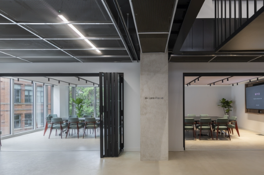 Modern meeting space with large windows for collaboration and productivity events.